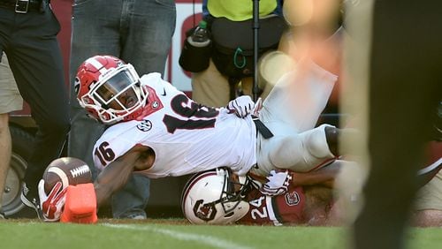 Georgia Bulldogs wide receiver Isaiah McKenzie reaches into the end zone for a touch down in front of South Carolina Gamecocks defensive back D.J. Smith. BRANT SANDERLIN/BSANDERLIN@AJC.COM