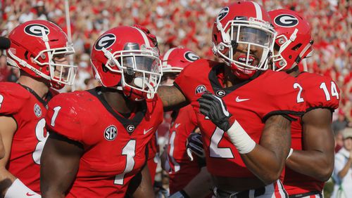 Georgia running back Sony Michel (1) celebrates with wide receiver Jayson Stanley (2) after scoring on an 8-yard run in the first quarter against South Carolina at Sanford Stadium in Athens, Ga., on Saturday, Nov. 4, 2017, (Bob Andres/Atlanta Journal-Constitution/TNS)