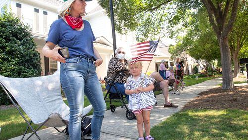 Jennifer Fitzgerald (L) and her daughter Vivian, 3, linger after the fourth of July Drive-By Parade, passed through the neighborhood in Powder Springs Saturday, July 4, 2020. STEVE SCHAEFER FOR THE ATLANTA JOURNAL-CONSTITUTION