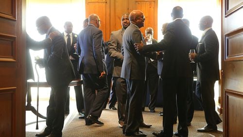 New and old members of 100 Black Men of Atlanta mingle last week at The Commerce Club.