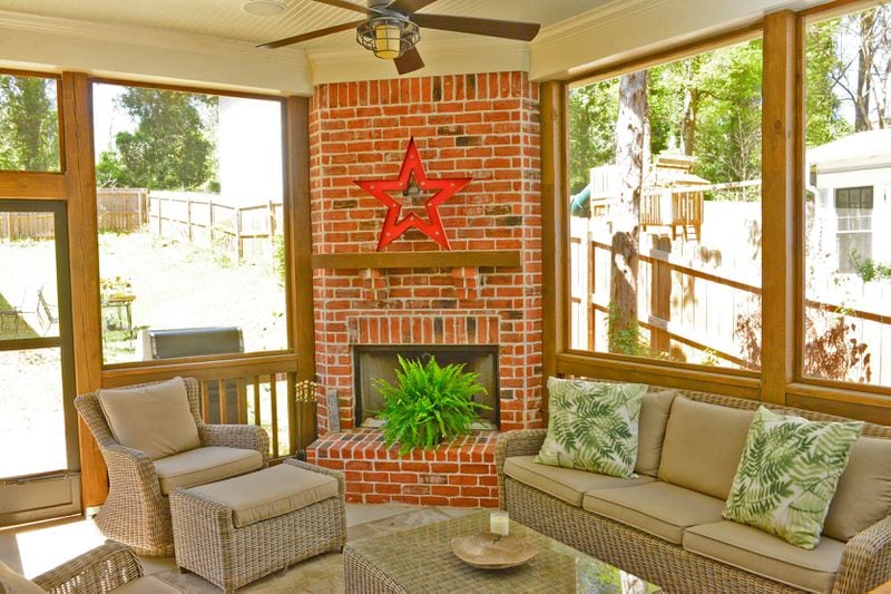 On the screened back porch, Herring and Crespino chose weather-resistant outdoor furniture from AuthenTEAK in west Midtown. The rustic star was a purchase from Target.
