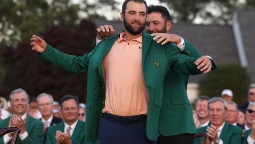 Scottie Scheffler receives the green jacket from 2023 winner Jon Rahm at the 2024 Masters Tournament at Augusta National Golf Club, Sunday, April 14, 2024. Jason Getz / Jason.Getz@ajc.com)

