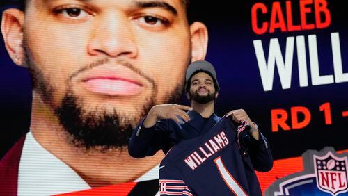 Southern California quarterback Caleb Williams celebrates after being chosen by the Chicago Bears with the first overall pick during the first round of the NFL football draft, Thursday, April 25, 2024, in Detroit. (AP Photo/Jeff Roberson)