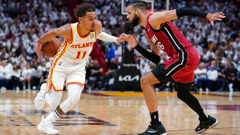 Atlanta Hawks guard Trae Young (11) looses control of the ball as he drives to the basket against Miami Heat forward Caleb Martin (16) during the second half of Game 5 of an NBA basketball first-round playoff series, Tuesday, April 26, 2022, in Miami. (AP Photo/Wilfredo Lee)