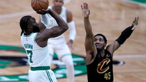 Boston Celtics guard Jaylen Brown (7) shoots as Cleveland Cavaliers' Donovan Mitchell defends during the first half of Game 1 of an NBA basketball second-round playoff series Tuesday, May 7, 2024, in Boston. (AP Photo/Charles Krupa)