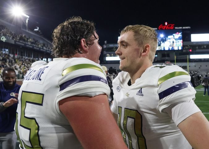 Georgia Tech Yellow Jackets offensive lineman Connor Scaglione (65) celebrates with quarterback Haynes King (10) after Tech won.  (Bob Andres for the Atlanta Journal Constitution)