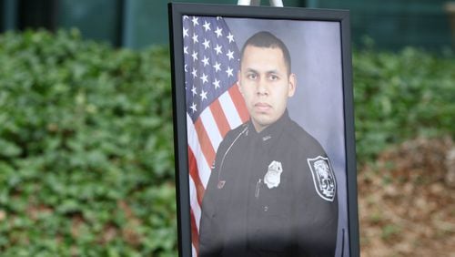 3/13/19 - Tucker  - A photo of DeKalb County Officer Edgar Isidro Flores, who died in the line of duty in December, is displayed at DeKalb County police headquarters in Tucker, Georgia on Wednesday, March 13, 2019. DeKalb County police K-9 Indi will return to work after being shot and losing an eye while helping human police officers track down his killer.   EMILY HANEY / emily.haney@ajc.com
