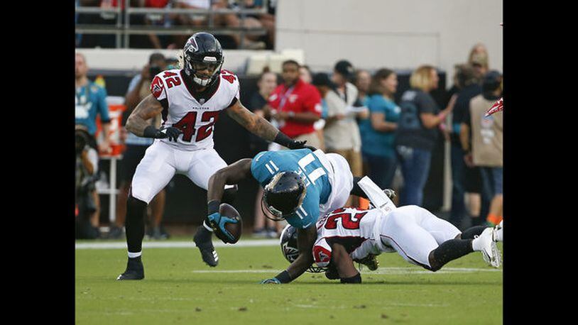 Jacksonville Jaguars wide receiver Marqise Lee (11) is injured as he is tackled by Atlanta Falcons cornerback Damontae Kazee, right, and linebacker Duke Riley (42) during the first half of an NFL preseason football game, Saturday, Aug. 25, 2018, in Jacksonville, Fla. Lee was taken off the field on an medical cart after the play. (AP Photo/Stephen B. Morton)