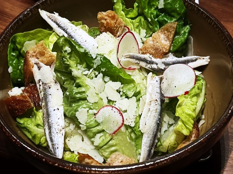 The Caesar salad at Foundation Social Eatery gets a rich boost of umami from whole anchovy filets. Henri Hollis/henry.hollis@ajc.com