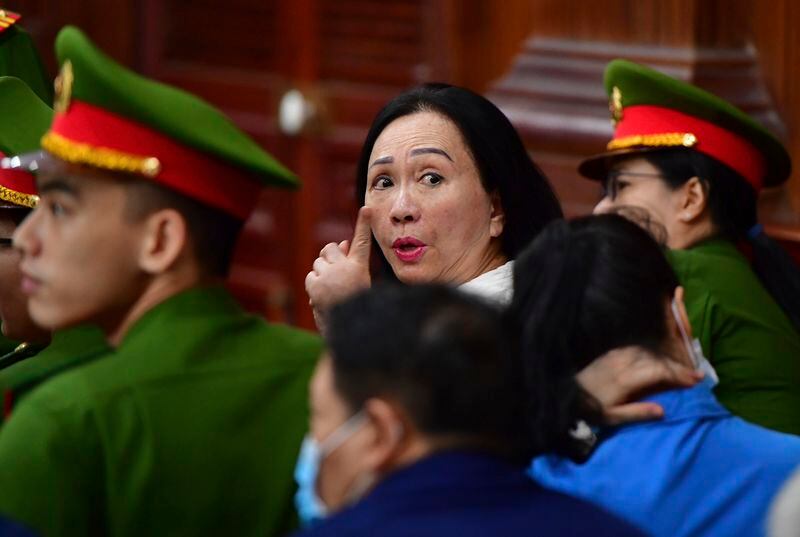 Business woman Truong My Lan, center, attends a trial in Ho Chi Minh City, Vietnam on Thursday, April 11, 2024. The real estate tycoon may face the death penalty if convicted of allegations that she siphoned off an amount of $12.5 billion, nearly 3 percent of Vietnam's 2022 GDP, in its largest financial fraud case. (Thanh Tung/VnExpress via AP)