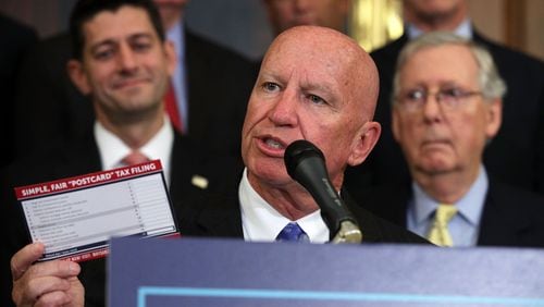 Rep. Kevin Brady holds up a tax filing "postcard" during a press event on tax reform on Sept. 27, 2017, at the U.S. Capitol.