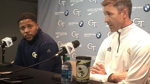 New Georgia Tech co-defensive coordinator and safeties coach Nathan Burton (right, next to new running backs coach Tashard Choice) met with media Saturday January 5, 2019 at McCamish Pavilion. In front of him is a Tech-branded tumbler that he has used for several years. (AJC photo by Ken Sugiura)