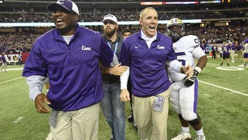 Cartersville head coach Joey King (foreground right) celebrates with other coaching staff during Cartersville's 10-0 win over Buford in the GHSA Class AAAA State Championship at the Georgia Dome on Saturday December 12, 2015. HYOSUB SHIN / HSHIN@AJC.COM