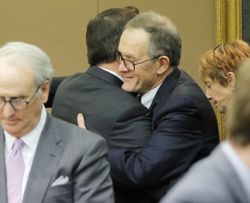 Defendant John Butters (right) hugs co-defendant David Cohen after they were each found not guilty on Wednesday, April 11, 2018, in the Waffle House sex tape trial. A Fulton County jury decided that a sex video involving Waffle House chairman Joe Rogers Jr. was not recorded illegally. (Bob Andres bandres@ajc.com)
