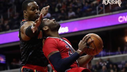 John Wall of the Washington Wizards puts up a shot in front of Dwight Howard of the Atlanta Hawks during the first half at Verizon Center on March 22, 2017 in Washington, DC. (Photo by Rob Carr/Getty Images)