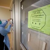 A sign advises medical personnel and visitors to take precautions before entering rooms with patients infected with COVID-19 at the Northeast Medical Georgia Center in Gainesville, GA, on Monday, February 5, 2024.Miguel Martinez /miguel.martinezjimenez@ajc.com
