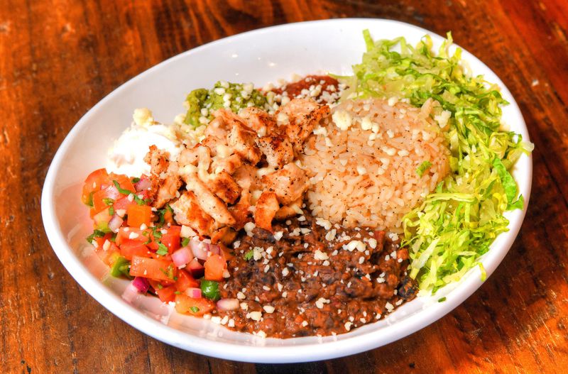 Cantina Bowl, with rice and beans, charred corn, romaine, salsa, guacamole, cotija cheese, and chicken. CONTRIBUTED BY CHRIS HUNT PHOTOGRAPHY