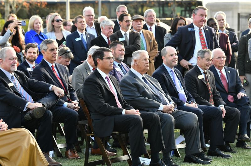 Guests including Lieutenant Governor Geoff Duncan (center left) and Speaker of the House David Ralston (center right) attend a press conference at Liberty Plaza across from the Georgia State Capitol in Atlanta on Thursday, December 16, 2021. Electric vehicle maker Rivian on Thursday confirmed its plans to build a $5 billion assembly plant and battery factory in Georgia, which Gov. Brian Kemp called "the largest single economic development project ever in this state's history." (Hyosub Shin / Hyosub.Shin@ajc.com)