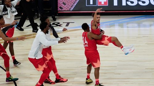 Team Giannis' Trae Young of the Atlanta Hawks is celebrated after making a three-point basket during to end the first half of the NBA All-Star basketball game Sunday, Feb. 16, 2020, in Chicago.