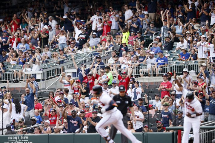 Fans jump from their seats after Atlanta Braves left fielder Adam Duvall hits a solo home run during the second inning Sunday, June 12, 2022, in Atlanta. (Miguel Martinez / miguel.martinezjimenez@ajc.com)