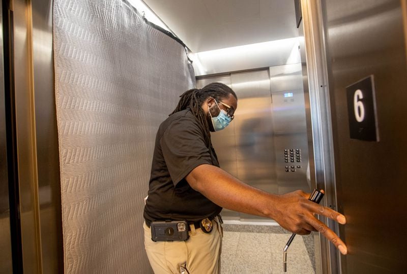Inspector Kenny Leatham works on the annual inspection of elevators at the Nathan Deal Judicial Center on Wednesday. The state regulations for elevator safety, enforced by the Georgia Department of Insurance and Safety Fire, span 32 dense pages and cover everything from freight elevators to hand-powered lifts to chairlifts mounted in staircases. (Jenni Girtman for The Atlanta Journal-Constitution)