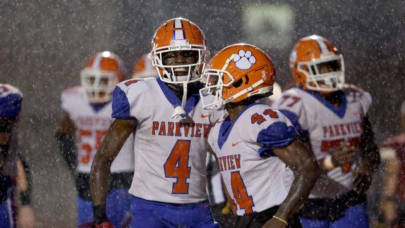 081722 Johns Creek, Ga.: During a rain storm, Parkview wide receiver Mike Matthews (4) celebrates his first touchdown with Zach Hill (44) during their game against Johns Creek at Johns Creek high school Wednesday, August 17, 2022, in Johns Creek, Ga. Parkview won 52-7. Matthews was the leading receiver with six catches for 111 yards and two touchdowns. He also had an interception on defense. (Jason Getz / Jason.Getz@ajc.com)