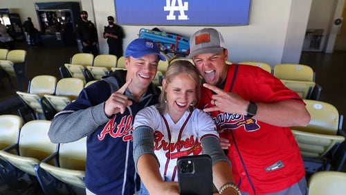 Braves fans Frank Schottgen (from left) and Erica and Trey Cockrell, all from Mobile, Ala., take a selfie photo as they arrive at Dodger Stadium to watch their team play the Dodgers in Game 4 of the NLCS on Wednesday. (Curtis Compton / Curtis.Compton@ajc.com)