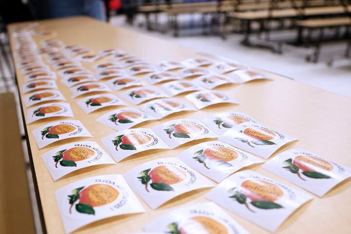 Stickers are ready to be handed out at Dresden Elementary School during election day on Tuesday, December 6, 2022. The race between Warnock and Republican challenger Herschel Walker came to the last day for the US Senate runoff. Miguel Martinez / miguel.martinezjimenez@ajc.com
