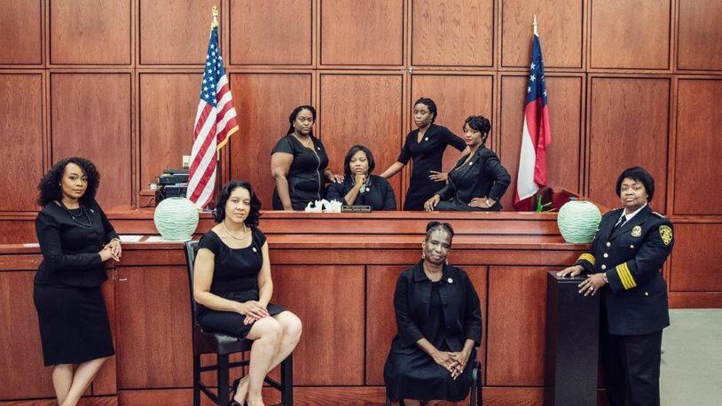 This photo went viral showing the eight African-American women who are leading the City of South Fulton’s law enforcement and municipal court system. They are, front row, left to right: City Solicitor LaDawn Jones, Court Administrator Lakesiya Cofield, Public Defender Viveca R. Famber Powell, Interim Police Chief Sheila Rogers. Back row, left to right: Clerk Kerry Stephens, Chief Judge Tiffany Carter Sellers, Clerk of Court Ramona Howard, Clerk Tiffany Kinslow. (Photo by Reginald Duncan, Cranium Creation)