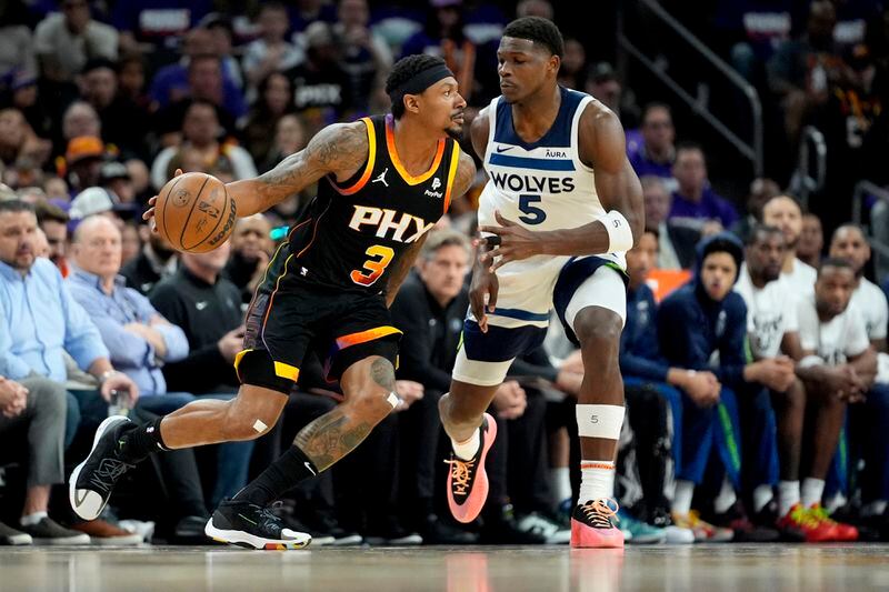 Phoenix Suns guard Bradley Beal (3) drives as Minnesota Timberwolves guard Anthony Edwards (5) defends during the first half of Game 3 of an NBA basketball first-round playoff series, Friday, April 26, 2024, in Phoenix. (AP Photo/Matt York)