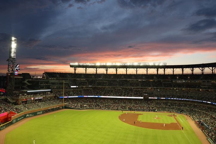 Fans in the upper deck enjoy the sunset Monday night at Truist Park. (Miguel Martinez/miguel.martinezjimenez@ajc.com)