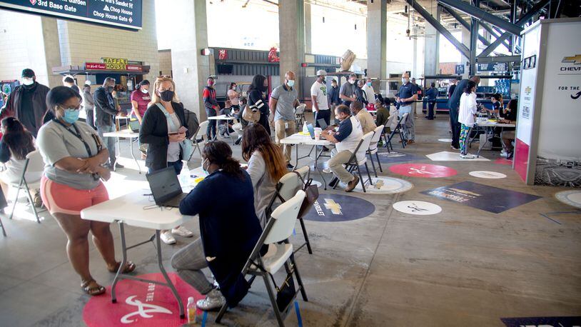 Deaths from COVID-19 have plunged in Georgia due to the early success of vaccination campaigns, experts say. Earlier this week, people lined up at a free vaccination clinic at Truist Park sponsored by the Atlanta Braves. (Photo: Steve Schaefer for The Atlanta Journal-Constitution)