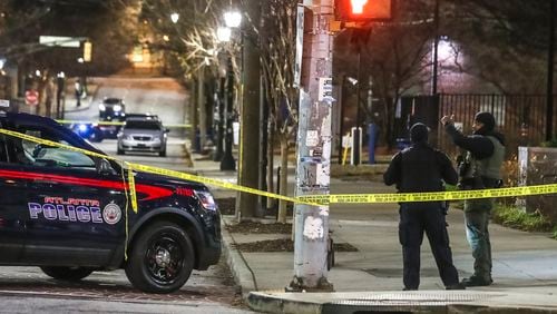Authorities investigate a shooting in December. John Spink / John.Spink@ajc.com