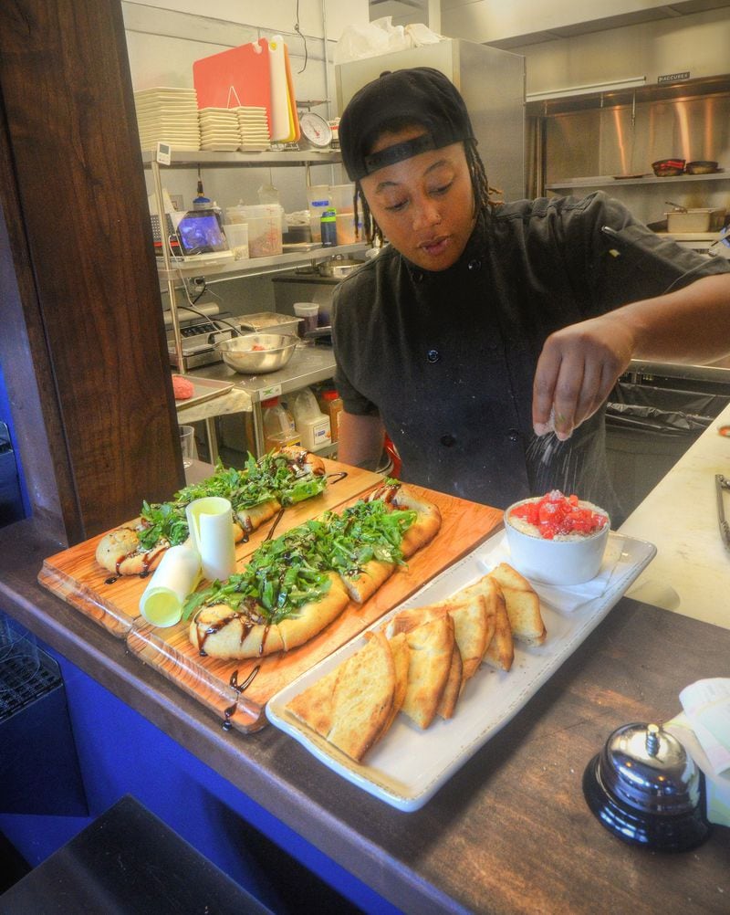 Executive chef Chantel Mines puts final touches on an order of The Speckled Goat and Sausage Dip prior to serving at the Lost Druid.