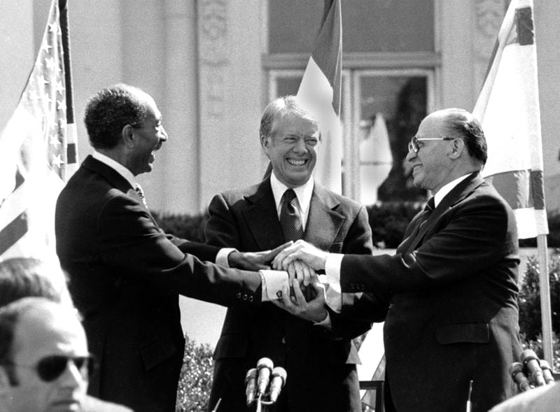 Egyptian President Anwar Sadat, left, U.S. President Jimmy Carter, center and Israeli Prime Minister Menachem Begin clasp hands after signing the peace treaty between Egypt and Israel in 1979.
AP Photo/ Bob Daugherty, File)
