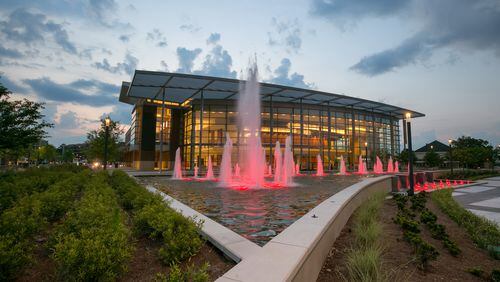 The fountain is lit up with red lights in front of the Sandy Springs Performing Arts Center at sun set in Sandy Springs Saturday, June 9, 2018, in Sandy Springs, Ga.