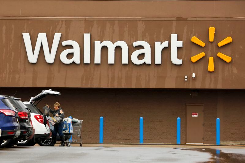 FILE - A shopper loads her car after shopping at a Walmart in Pittsburgh, Thursday, Feb. 22, 2018. Walmart announced Tuesday, April 30, 2024, is closing its health centers and virtual care service, as the retail giant has struggled to find success with the offerings. AP Photo/Gene J. Puskar, File)