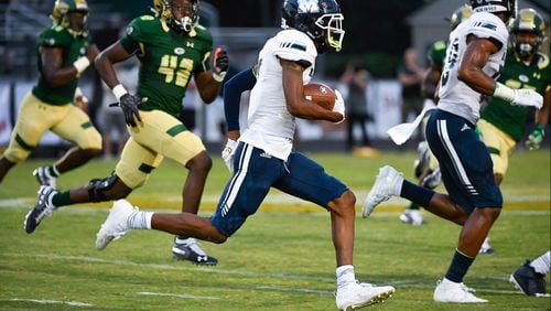 Ricky White of Marietta carries against Grayson during the first half of Friday's game in Loganville. (John Amis/Special)