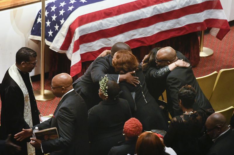 Family members are hugged by clergy during a memorial service for CDC researcher Timothy Cunningham, who was pulled from the Chattahoochee River after being missing for seven weeks. The service was held  at Morehouse  College April 21. (John Amis Contributed)