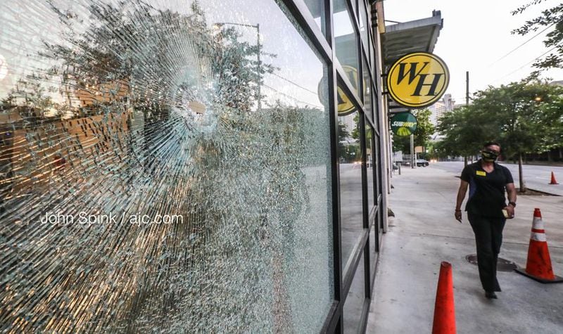Bullets hit the front of the Waffle House on Courtland Street and injured an innocent bystander, according to a spokeswoman for the restaurant.