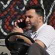 Atlanta Braves general manager Alex Anthopoulos talks on the phone during spring training workouts at CoolToday Park, Wednesday, Feb. 21, 2024, in North Port, Florida. (Hyosub Shin / Hyosub.Shin@ajc.com)