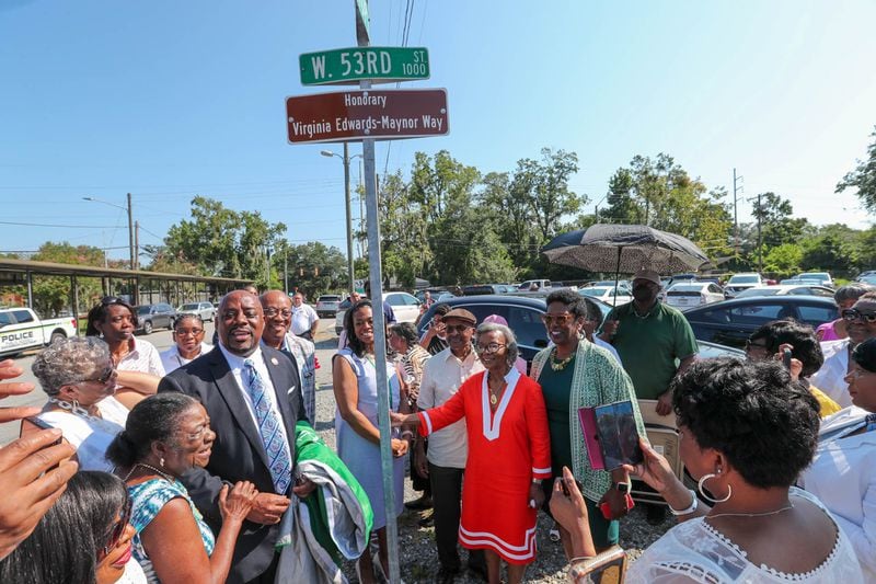 Virginia Edwards-Maynor is surrounded by dignitaries, supporters, and family as the sign was unveiled designating a portion of Hopkins Street as Virginia Edwards-Maynor Way on Tuesday, August 8, 2023.