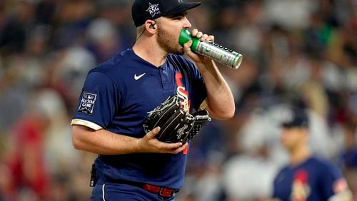 American League's Liam Hendriks, of the Chicago White Sox, right, takes oxygen on the mound during the ninth inning of the MLB All-Star baseball game, Tuesday, July 13, 2021, in Denver. (AP Photo/Jack Dempsey)