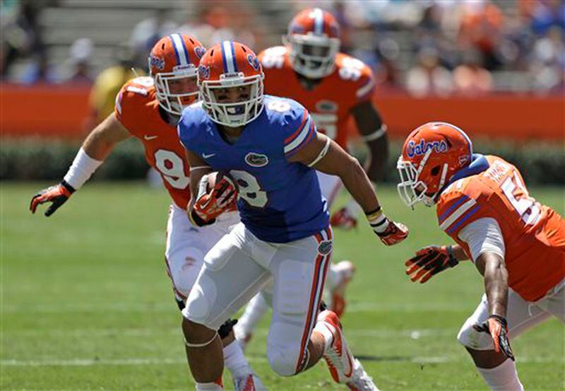 Florida running back Trey Burton (8) looks for a way around linebacker Michael Taylor, right, and Joey Ivie, left, during a spring NCAA college football scrimmage, Saturday, April 6, 2013, in Gainesville, Fla. (AP Photo/John Raoux) Florida's Trey Burton (8) looks for a way around linebacker Michael Taylor, right, and Joey Ivie, left, during a spring NCAA college football scrimmage, Saturday, April 6, 2013, in Gainesville, Fla. (AP Photo/John Raoux)
