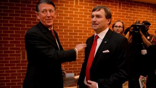 December 7, 2015 Athens, GA: Kirby Smart, right, was given a "Go get em" and a pat on the back by UGA Director of Athletics Greg McGarity before Smart was introduced as the new coach of the University of Georgia during a press conference Monday December 7, 2015 Smart was a former UGA player and coach. Smart replaced Mark Richt after 15 seasons at the helm of the Bulldogs. BRANT SANDERLIN/BSANDERLIN@AJC.COM