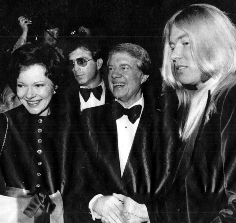 Jan. 19, 1977 - President-elect Jimmy Carter and wife Rosalynn say hello to an old friend at Gala. Rock musician Gregg Allman was one of the performers at the Kennedy Center show. (AP) 1977