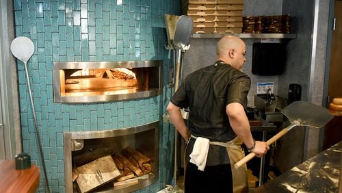 The wood-fired pizza oven is part of the appeal of Forno Vero Neapolitan Kitchen at Marietta Square Market. RYON HORNE / RHORNE@AJC.COM
