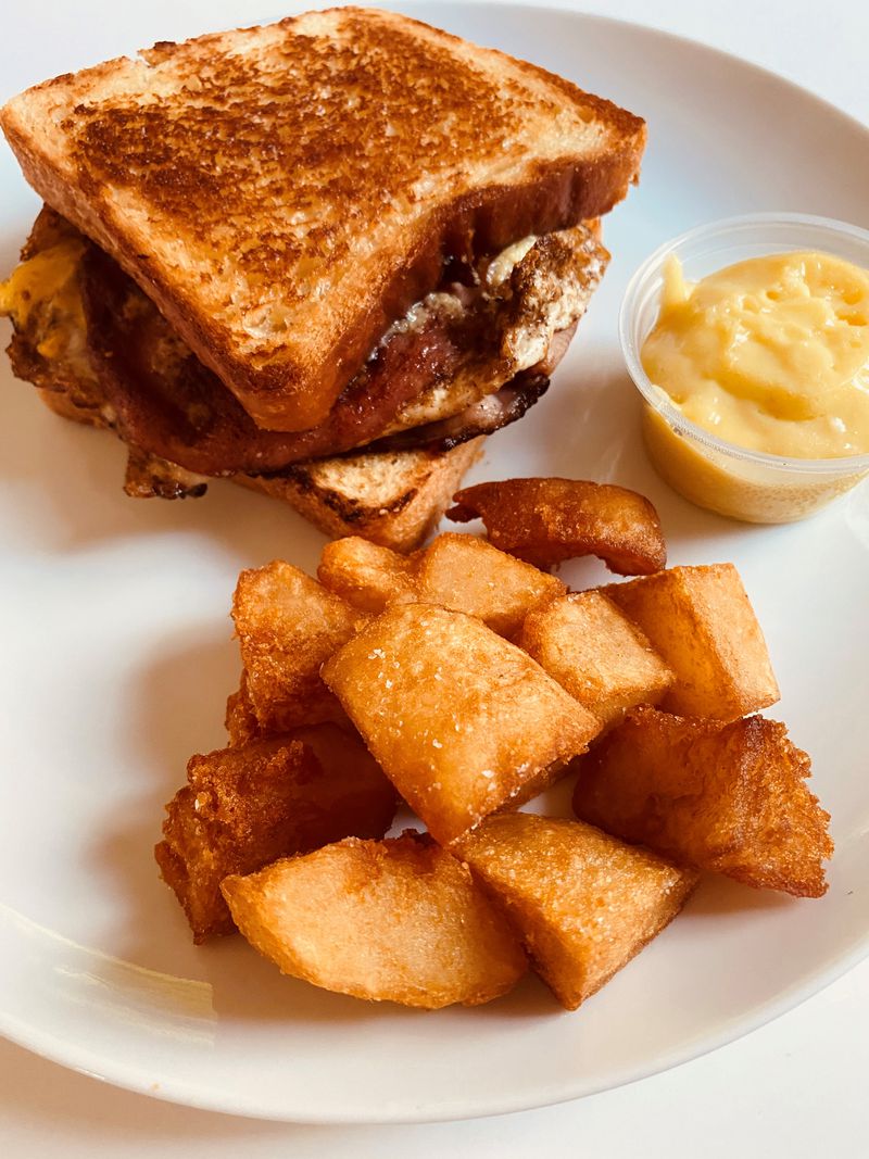 The Bread & Butterfly egg sandwich comes with crispy fries and aioli. Bob Townsend for The Atlanta Journal-Constitution