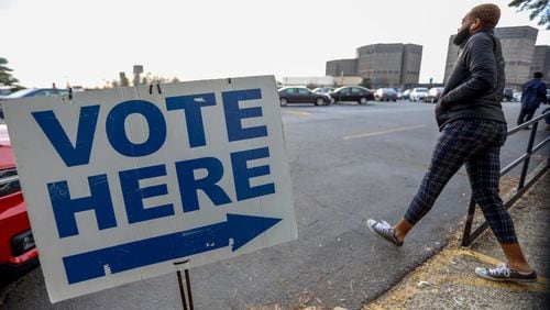 A person walks outside of the Voter Registration and Elections Office in Dekalb County during of the first day of early voting on Monday, March 2, 2020.