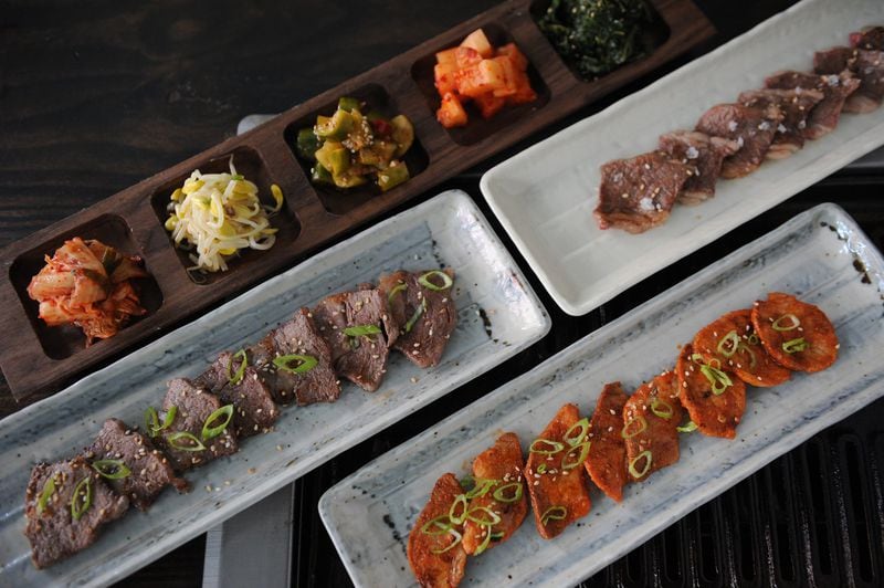 Trays of banchan side dishes and grilled meats at Char Korean Bar & Grill in Inman Park. (BECKY STEIN PHOTOGRAPHY)